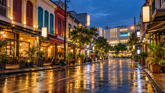 Illustration: shophouse street in downtown Batam glowing after evening rain
