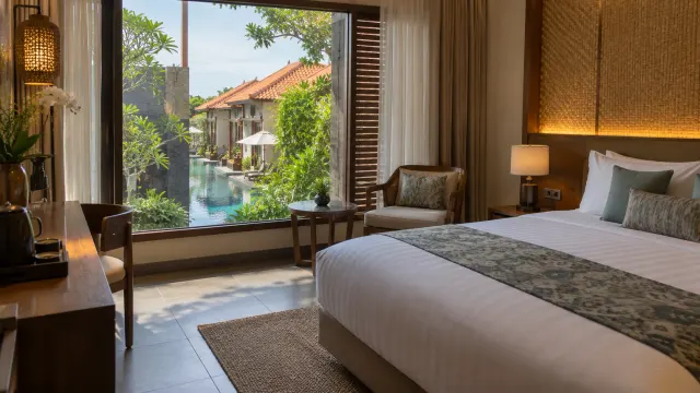 A neatly made guest room with a window view of a boutique hotel — Woda Villa & Spa, a boutique hotel in Bengkong, Batam