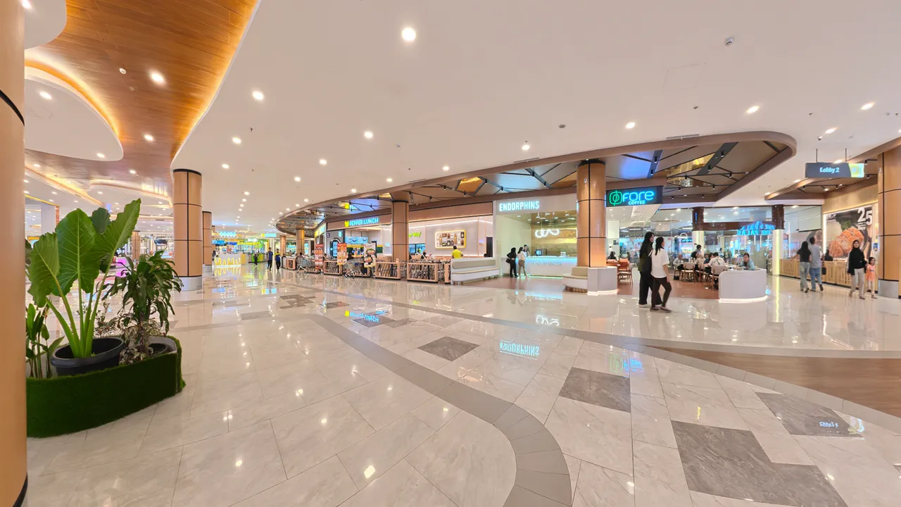 K Square Batam ground floor — marble lobby with Endorphins, Fore Coffee and food kiosks under a curved wood ceiling