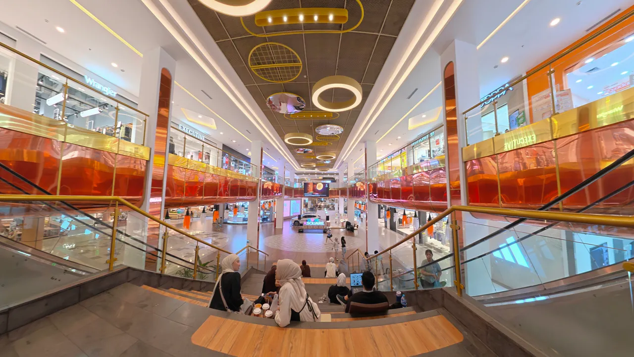 K Square Batam — indoor amphitheatre steps looking down the atrium with shops on three levels